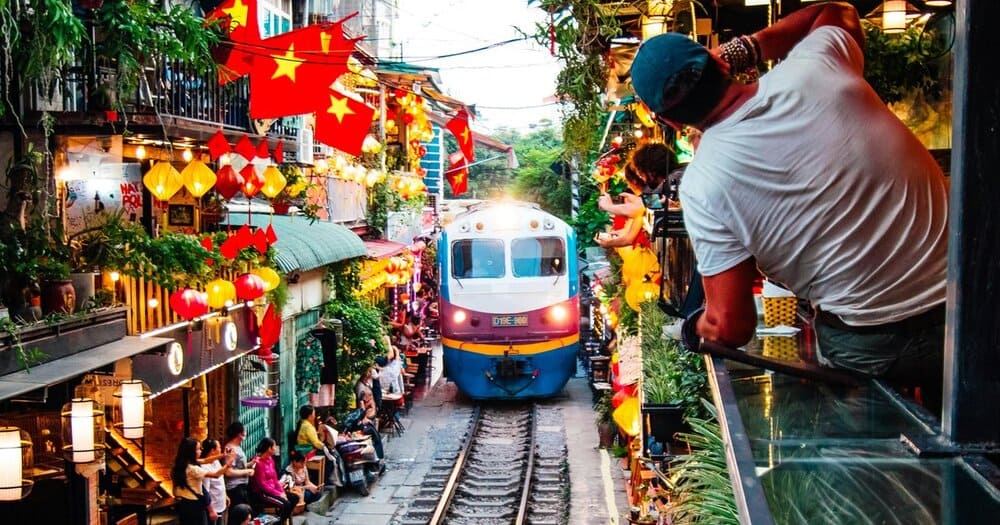 Watch the train pass just inches away – one of the most thrilling moments in One day in Hanoi.